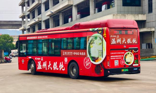 大红色的温州大馄饨公交车身广告行驶中