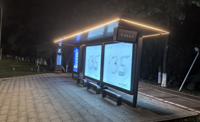 东莞候车亭站牌在夜间亮灯场景实拍图，富有现代感的松山湖地区公交站牌